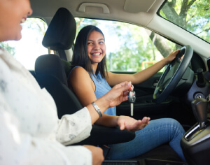 An Instructor giving car keys to student